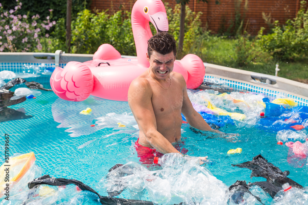 Ecology, plastic trash, environmental emergency and water pollution - shocked man standing in a dirty swimming pool