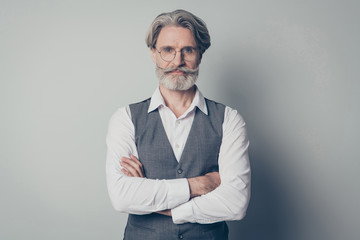 Photo of aged macho business man boss standing calm not smiling serious look arms crossed wear specs office white shirt waistcoat isolated grey color background