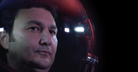 Wall Mural - close up 4k shot of the young courageous male astronaut in space helmet. he is exploring outer space