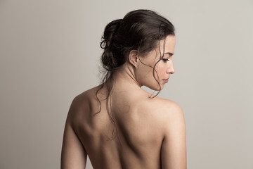 natural beauty concept young woman with wet hair in bun profile and back studio shot