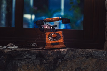 Fototapete - old brown wooden phone near the window.