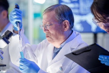 Wall Mural - Asian scientist use microscope