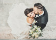 © Igor - Beautiful wedding couple cuddling on their wedding day