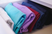 Lot Of Different Folded Clothes Perfectly Arranged In A Closet - Marie Kondo Konmari Method Concept
