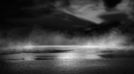 Wall Mural - dramatic black and white background. cloudy night sky, moonlight, reflection on the pavement. smoke 