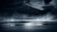 Dramatic Black And White Background. Cloudy Night Sky, Moonlight, Reflection On The Pavement. Smoke And Fog On A Dark Street At Night.