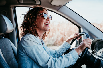 young beautiful woman driving a car. travel concept