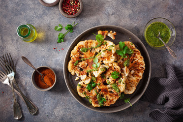 Wall Mural - cauliflower steaks with herb sauce and spice. plant based meat substitute