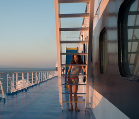 Wall Mural - Asain teen in shorts, sandals and tube top framed by stairs with blue sky in the background