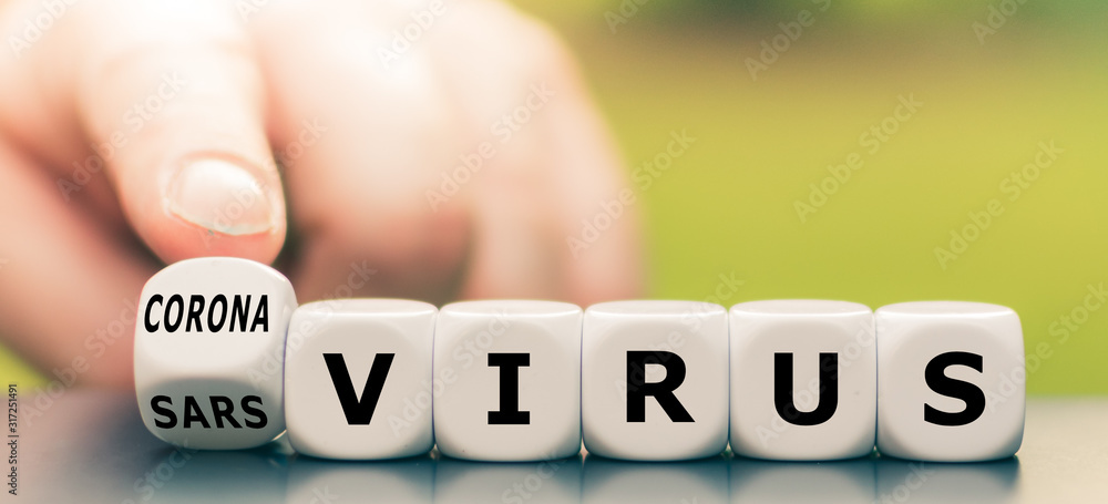 Hand turns a dice and changes the expression "sars virus" to "corona virus". - obrazy, fototapety, plakaty 