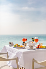 Luxury breakfast food on white table with beautiful tropical sea view background, morning time summer holiday and romantic vacation concept, luxury travel and lifestyle