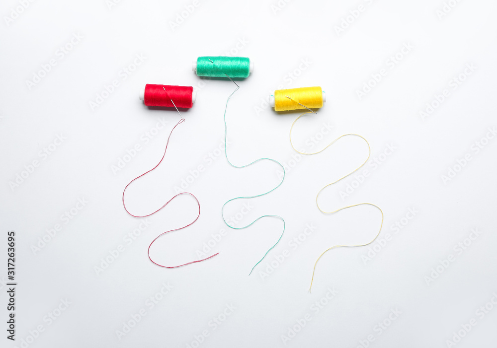 Sewing threads on white background