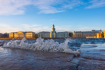 Wall Mural - View of the embankment of the river Nez with water splashes during the flood, in the distance the Kunstkamera building.