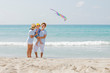 © Tawan - Happy asian family enjoy with kine on the beach