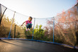 © Martinan - Little kid bouncing off the trampoline bed