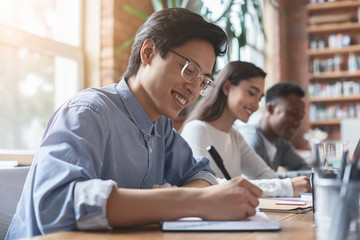 Sticker - Young asian guy taking notes, having business meeting with colleagues