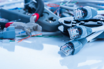 Tools and cables used in service of network ethernet patch cord close-up