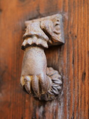 Hand-shaped door knocker