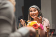 selective focus of smiling asian woman eating pasta and talking with friend during dinner
