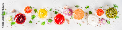 Fotomural Set of sauces in small bowls - ketchup, mayonnaise, mustard, bbq sauce, pesto, classic burger sauce, with spices and herbs in