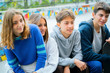 © PhotoAlto - Smiling teenage friends sitting outdoors