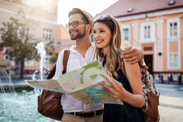 Wall Mural - summer holidays, dating, love and tourism concept. smiling couple in the city