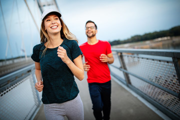 beautiful couple running in nature living healthy