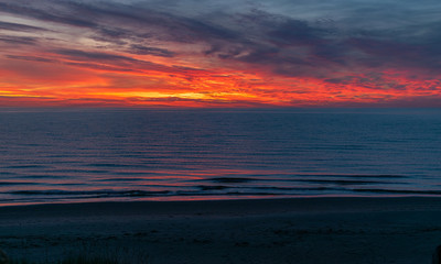 Wall Mural - sea sunset landscape with colorful skies and dark water