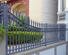 Ornate Gold Spiked Wrought Iron Fence.