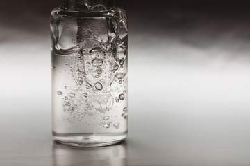 Wall Mural - Macro photo of bottle with fluid collagen of hyaluronic acid