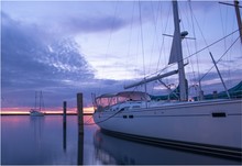Sailing Boat On The Calm Sea Under The Breathtaking Sunrise Captured In Lexington Marina, Michigan