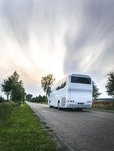 White City Bus On The Road In Scenic Countryside Of Poland. Cloudy Day. Excursions In Eastern Europe.Dramatic Sky.