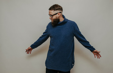 Handsome hipster guy with beard wearing blue blank sweatshirt with space for your logo or design. Mockup for print