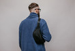 © San4ezz007 - Handsome hipster guy with beard wearing blue blank sweatshirt with waist bag. Mockup for print