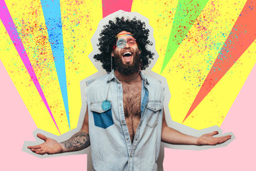 Friendly bearded young male hippie with curly hair in stylish sunglasses isolated on colorful background