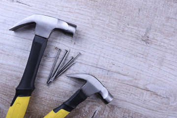 Sticker - Hammer iron and nails on wooden background