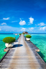 Canvas Print - Maldives water bungalows resort at islands beach. Indian Ocean, Maldives. Beautiful sea landscape, luxury resort and  sky. Beach  under wonderful sky