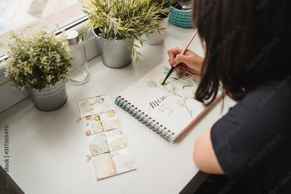 Crop from above view of unrecognizable woman drawing picture with ...