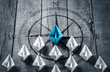 Blue Paper Boat Leading A Fleet Of Small White Boats With Compass Icon On Wooden Table - Leadership Concept