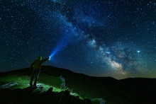Bright Starry Sky With The Milky Way On The Background Of Mountains And Hiker With Red Tent.