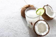 Fresh Coconut Water In Glass Cup On Light Background