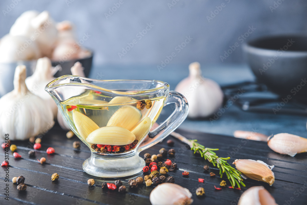 Gravy boat with garlic oil on table