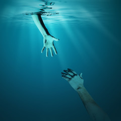 Wall Mural - Giving helping hand to drowning man concept