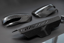 A Close-up On A Car Exterior Elements Made From Carbon Fiber Of Interwoven Black And Gray Color From Heavy-duty Yarns For The Production Of Light And Durable Elements In Industry. Tuning Body Parts.