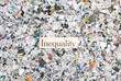 Newspaper confetti from above with the word Inequality