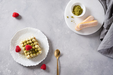 Matcha Tiramisu Dessert with raspberries and Green tea on concrete background. Superfoods, healthy nutrition. Menu, confectionery concept