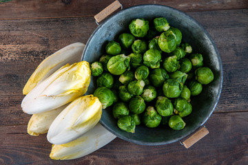 Wall Mural - sprouts and endives on wooden background, Belgian vegetables