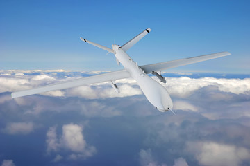 Wall Mural - military RC drone flies against backdrop of beautiful clouds on blue sky background. Elements of this image furnished by NASA