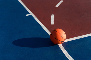 An orange ball on basketball court