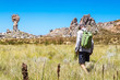 Man hiking to the rock formation Maltese Cross - a popular destination in the Cederberg, with fynbos vegetation, South Africa